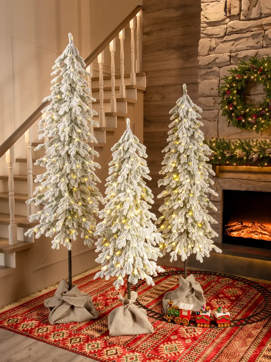 Christmas trees on wooden trunks artificial snow-covered molded with LED (set of 3)